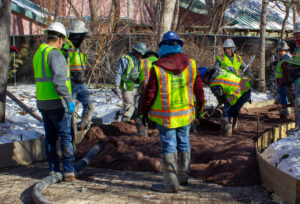 Commercial concrete workers preparing drilled piers deep foundation on jobsite