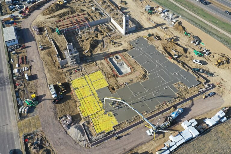 Aerial view of podium concrete slab construction and site preparation